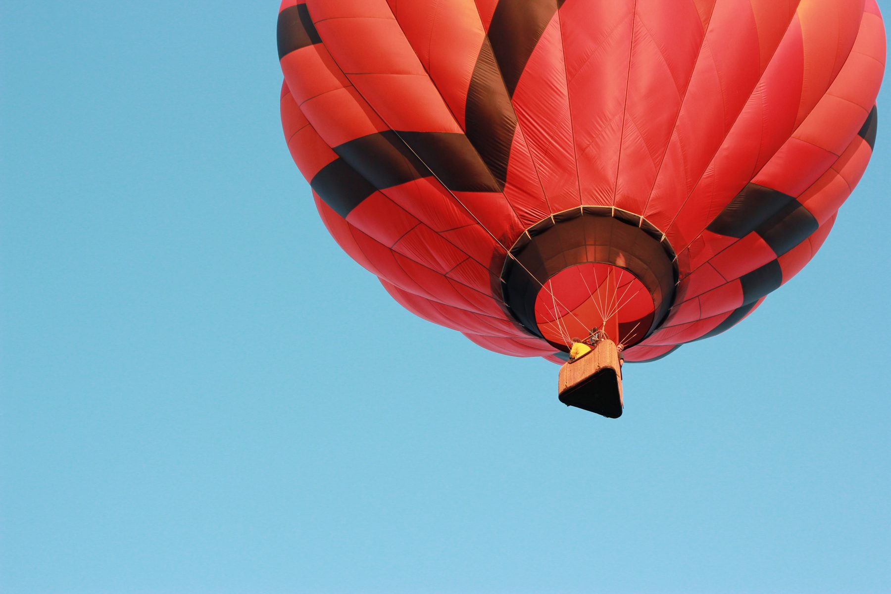 Red hot air balloon against blue sky